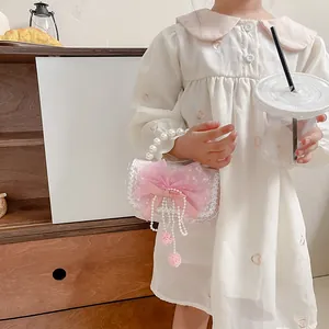 Chic girls' pink lace handbag with pearl handle and mesh bow for fashionable kids