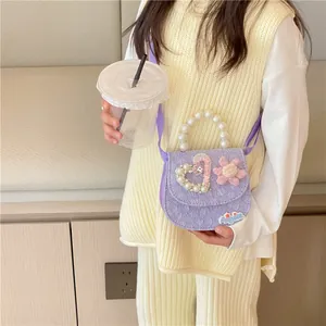 Chic purple girls' crossbody bag with pearl handle and heart rhinestone detail