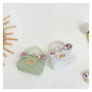 Detailed view of mini floral quilted girls' handbags with pearl handles and 3D flower accents