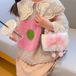 Fashionable girls' pearl handbag with pink bow and fur ball, paired with lace shirt