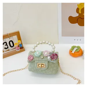 Detail of floral tweed kids handbag with pearl handle and 3D fabric flowers