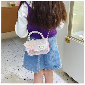 Back view of pink tweed kids handbag with pearl handle and bow for girls