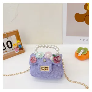 Detail of purple lace mini bag with pearl handle, 3D floral sequins, and gold chain strap