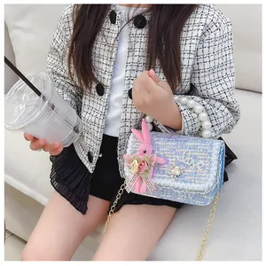 Detail of girls mini square bag with pearls handle, lace flowers and sequin fabric