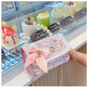 Pink tweed kids handbag with pearl handle, lace trim and sequin details in close-up