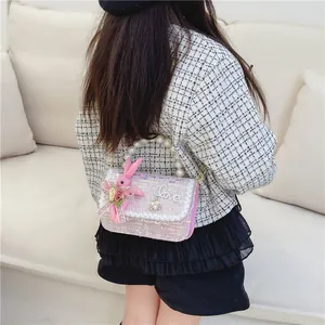 Chic pink tweed girls' crossbody bag with pearl handle and plush rabbit charm