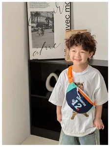 Detail of kids chest bag showing superstar cat print and adjustable orange strap