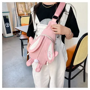 Detailed view of pink rabbit crossbody bag featuring 3D ears and embroidered Love text