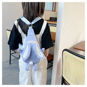 Close-up of cute light blue bunny backpack with plush tail and Love embroidery