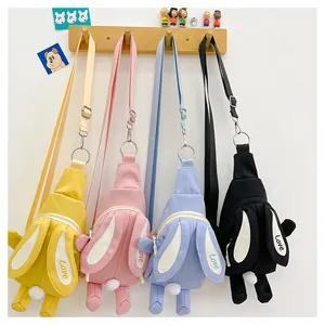 Detail of four colorful cute rabbit-shaped crossbody bags for kids hanging on hooks