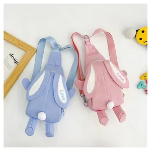 Detail view of rabbit-shaped crossbody bags featuring 3D ears and plush pom-pom tails