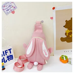 Detail of pink bunny crossbody bag with Love embroidery on ear and soft plush tail ball