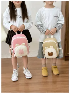 Detail of pink rabbit and khaki bear canvas mini backpacks for toddlers with cute 3D ears