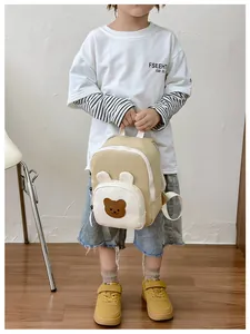 Detail view of mini canvas kids backpack with cute 3D bear ears in beige and white