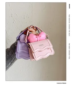 Close-up of pink and purple mini bags with wave stitching and a decorative bow