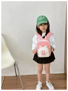 Detail view of a pink mini backpack for toddlers with cute rabbit design and white handles