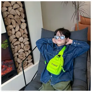Kids neon green Trend crossbody bag with adjustable strap shown on a young model
