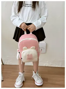 Detailed view of kids' cartoon backpack featuring 3D rabbit ears and pink contrast design