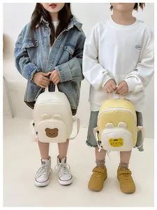 Detail showing two cute canvas backpacks with 3D bear and tiger patches for kids