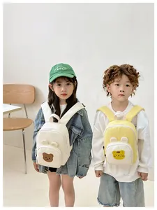 Close-up of mini canvas kids backpacks with cute cartoon animal patches and ears