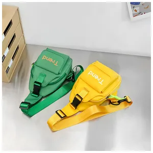 Top view of vibrant yellow and green nylon kids chest bags with Trend lettering