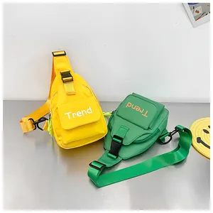 Detail of trendy canvas chest bags in bright yellow and green colors with adjustable straps