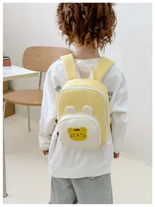 Detailed back view of a yellow canvas toddler backpack with cute cartoon ears and zipper