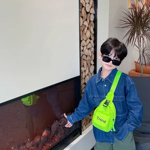 Neon green kids fanny pack with Trend print worn by a stylish boy in denim jacket
