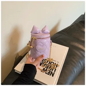 Detailed shot of lavender bucket bag with quilted heart pattern and golden chain