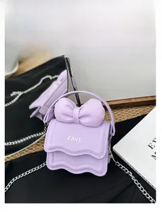 Close-up of purple mini bag with large bow detail and silver FAVE lettering