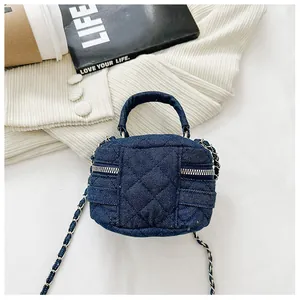 Close-up of quilted denim mini bag with silver chain strap and top handle design
