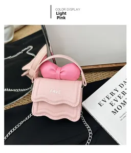 Detail of light pink mini handbag featuring wave-cut flap and bold 3D bow accent