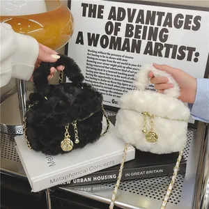 Plush faux fur mini crossbody bags in black and cream with rose gold metal charms