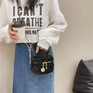 Quilted black faux fur crossbody bag with gold chain strap and floral zipper charm