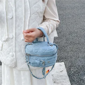 Mini quilted denim cylinder bag for girls featuring silver chain strap and top handle