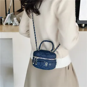 Quilted denim mini chain crossbody vanity bag with a top handle and shoulder strap