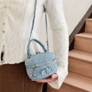 Light blue quilted denim mini crossbody bag with chain strap and top handle for girls
