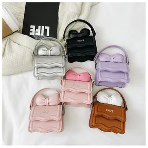 Detailed view of mini candy-colored handbags with bows and FAVE logo in various colors