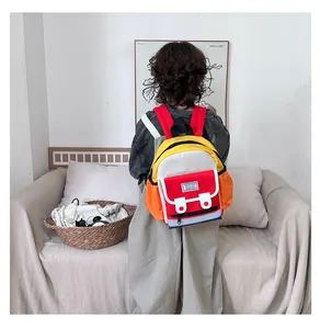 Colorful lightweight kids backpack with fashion label shown on child model at home