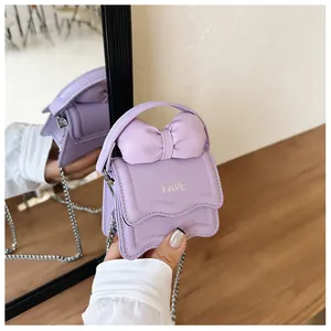 Detail showing lavender mini handbag with a 3D bow and silver FAVE lettering logo