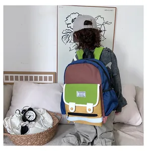 Rear view of schoolchild wearing a colorful contrast canvas backpack with wide green straps