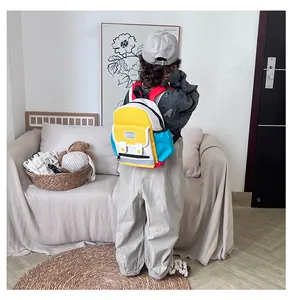 Detail view of colorful children's backpack with multi-pocket and mesh side pouch design