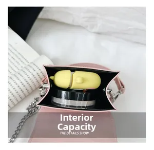 Internal capacity of pink mini crossbody bag showing small cosmetics and earphone case