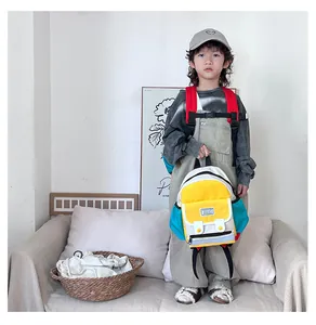 Detail of color-block kids backpack with chest buckle and side water bottle pocket
