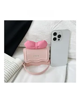 Detailed comparison of pink mini flap bag size with bow and FAVE embroidery