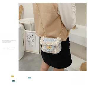 Detail of blue tweed crossbody bag with pearl trim and gold chain for girls