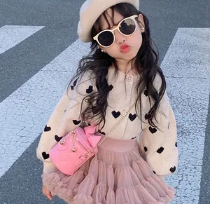 Detail of pink quilted bucket bag with gold chain for girls elegant fashion outfit