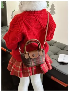 Dettaglio borsa bimba in tweed scozzese con manico in pelle e gancio metallico