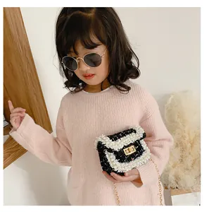 Detail of tweed children crossbody bag with pearl trim and gold chain strap