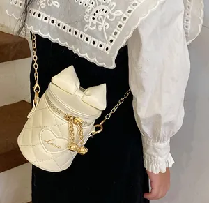 Close-up of quilted white bucket bag with large bow and embroidered heart detail